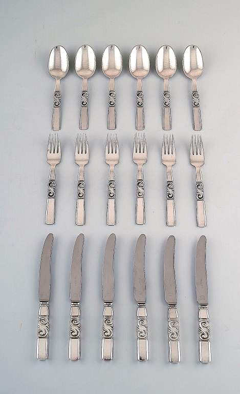 Georg Jensen. Cutlery, Scroll No. 22, full lunch service of hammered sterling 
silver.