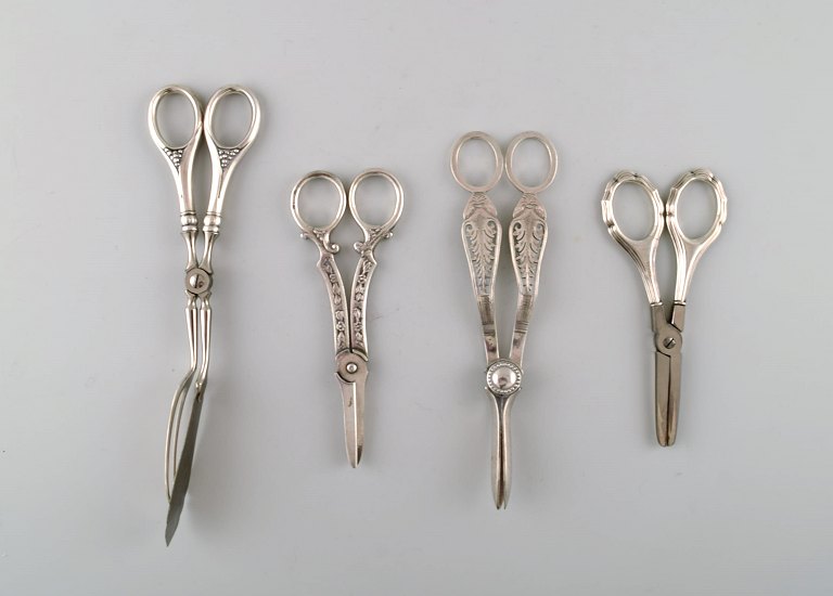 Four Danish and European scissors and tongs in silver, Grann & Laglye 830s.