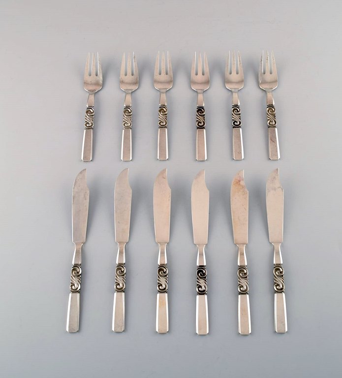 Georg Jensen. Cutlery, Scroll No. 22, Complete Fish Service of Hammered Sterling 
Silver.