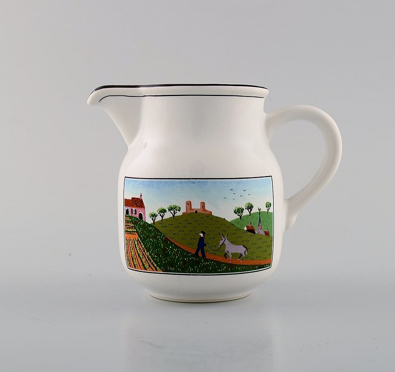 Villeroy & Boch Naif creamer in porcelain decorated with naivist village motif.