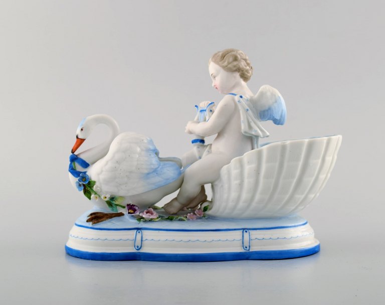 KPM, Berlin. Antique figure in beautiful overglaze. Amor with harp on a swan. 
Dated 1860-80.