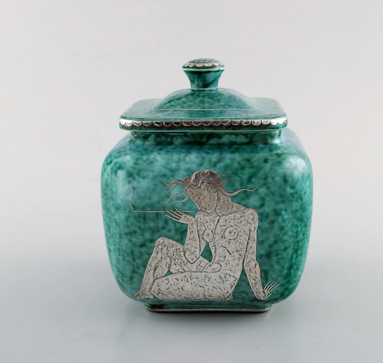 Wilhelm Kåge for Gustavsberg. Large Argenta art deco ceramic lidded jar 
decorated with nude woman in silver inlaid. Sweden 1940