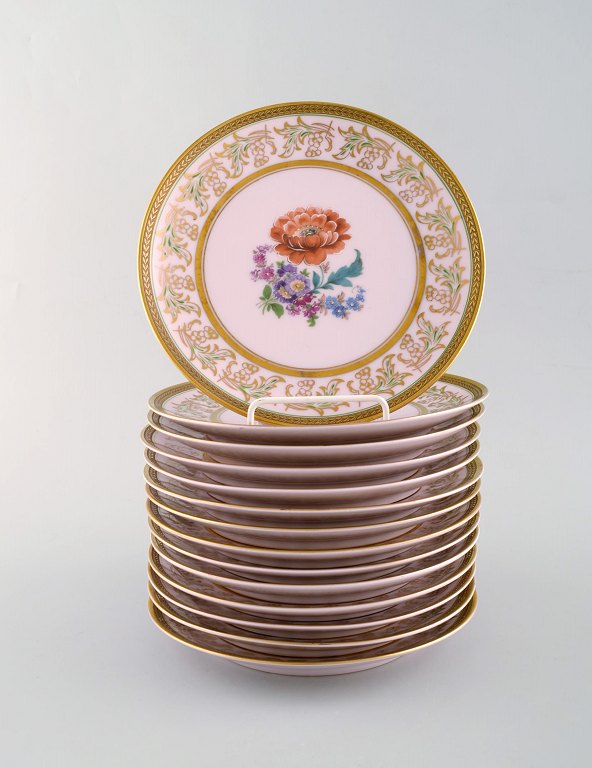 Johann Haviland Bavaria, Germany. 14 decorative plates in hand painted 
porcelain. Flowers on pink background and gold decoration. 1930