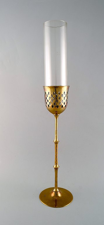 Bjørn Wiinblad (1918-2006). Tall "Hurricane" candle holder in brass with blue 
tinted glass. 1970