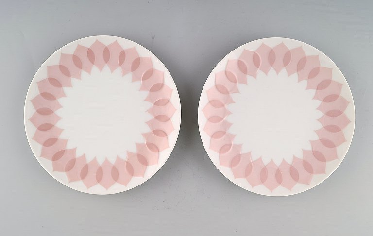 Bjørn Wiinblad for Rosenthal. "Lotus" porcelain service. Two plates decorated 
with pink lotus leaves. 1980s.
