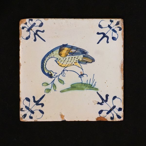 Polychromdekorierte holländische Fliese mit Vogelmotiv. Um 1620-40. Grösse: 
13x13cm