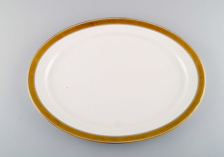 Royal Copenhagen Dagmar, White. Large oval serving dish in porcelain with gold 
edge. Model number 607/9010.
