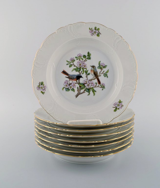 8 Royal Copenhagen "Spring" deep plates in porcelain with motifs of birds and 
foliage. 1980s. Model Number: 1533/2513.
