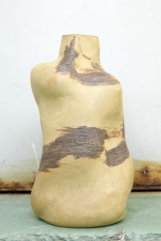 Christina Muff, Danish contemporary ceramicist (b. 1971). Bottleshaped 
sculptural vase in golden stoneware clay with slip from
Frederiksberg in Copenhagen. The vase is glazed inside with clear shiny glaze. 
The slip is painted on the outside.