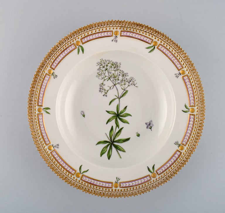 Royal Copenhagen flora danica deep plate in porcelain with hand-painted flowers 
and gold decoration. Early 20th century.
