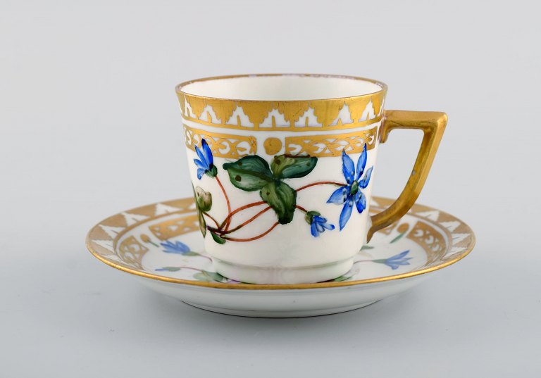 Royal Copenhagen coffee cup with saucer in hand-painted porcelain with gold 
decoration and flowers. Flora danica style, 1960s.
