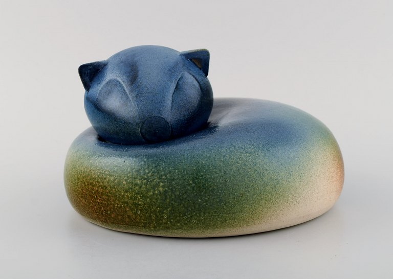 European studio ceramicist. Large unique figure of lying cat. Beautiful glaze in 
blue-green shades. 1980s.
