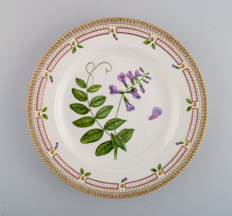 Royal Copenhagen Flora Danica middagstallerken i håndmalet porcelæn med blomster 
og gulddekoration. Modelnummer 20/3549.  
