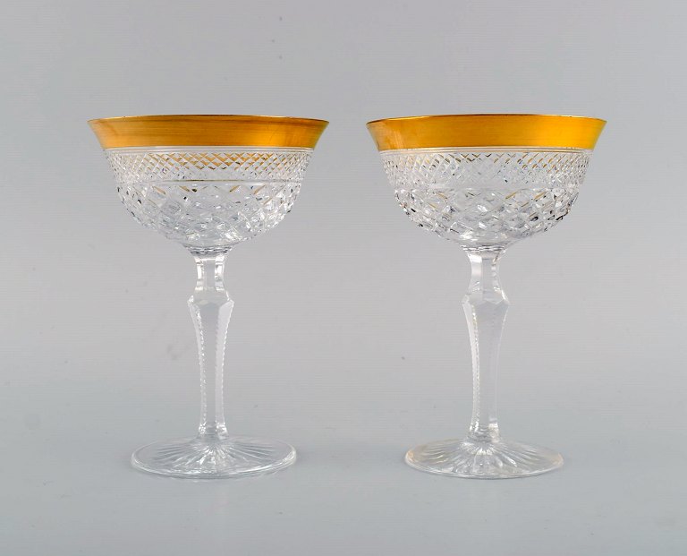 Two champagne glasses in mouth-blown crystal glass with gold edge. France, 
1930s.
