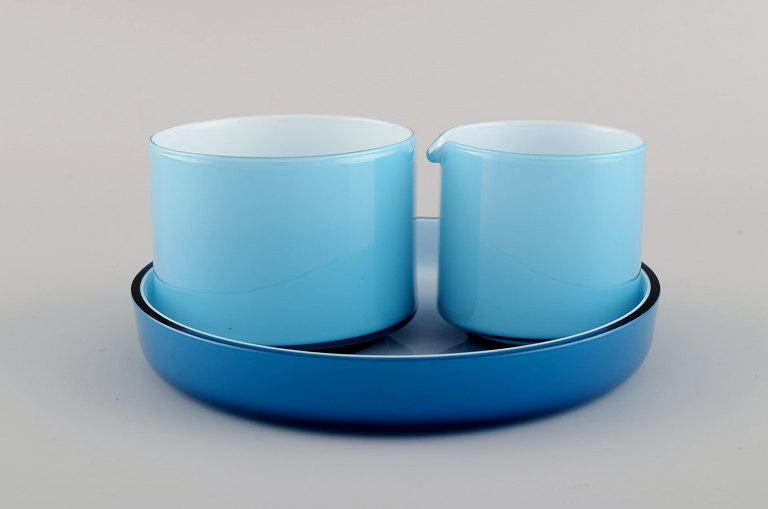 Michael Bang for Holmegaard. Palet Sugar / creamer set on serving tray in light 
blue mouth blown art glass. Mid-20th century.
