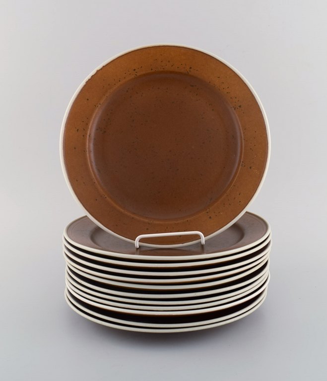 Stig Lindberg for Gustavsberg. Twelve Coq dinner plates. Beautiful glaze in 
brown shades. 1960s.
