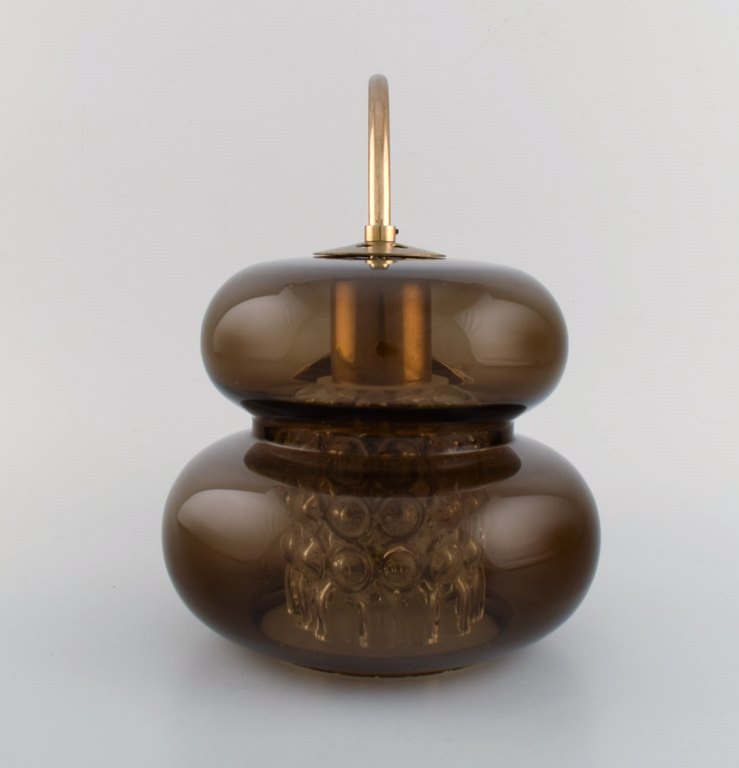 Carl Fagerlund for Orrefors. "Bubblan" wall lamp in smoky and clear art glass. 
Brass mounting. Rare model. Swedish design, 1970s.
