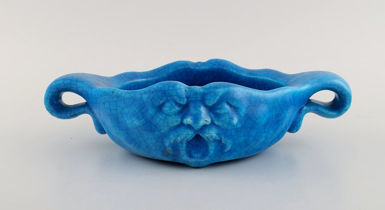 Edmond Lachenal (1855-1948), France. Unique art nouveau bowl with handles in 
glazed ceramics with a motif of grotesque. Beautiful turquoise glaze. Dated 
1910-1920.
