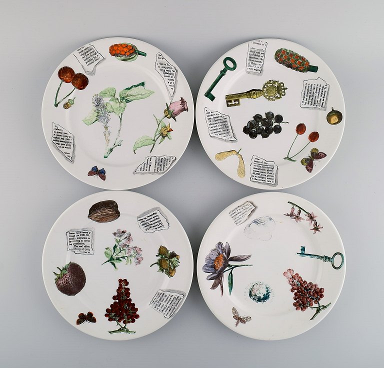 Fornasetti, Milano. Four plates in hand-painted porcelain. 1980s.
