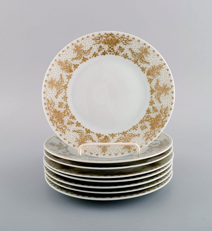 Bjørn Wiinblad for Rosenthal. Otte tallerkener i porcelæn med gulddekoration. 
1980