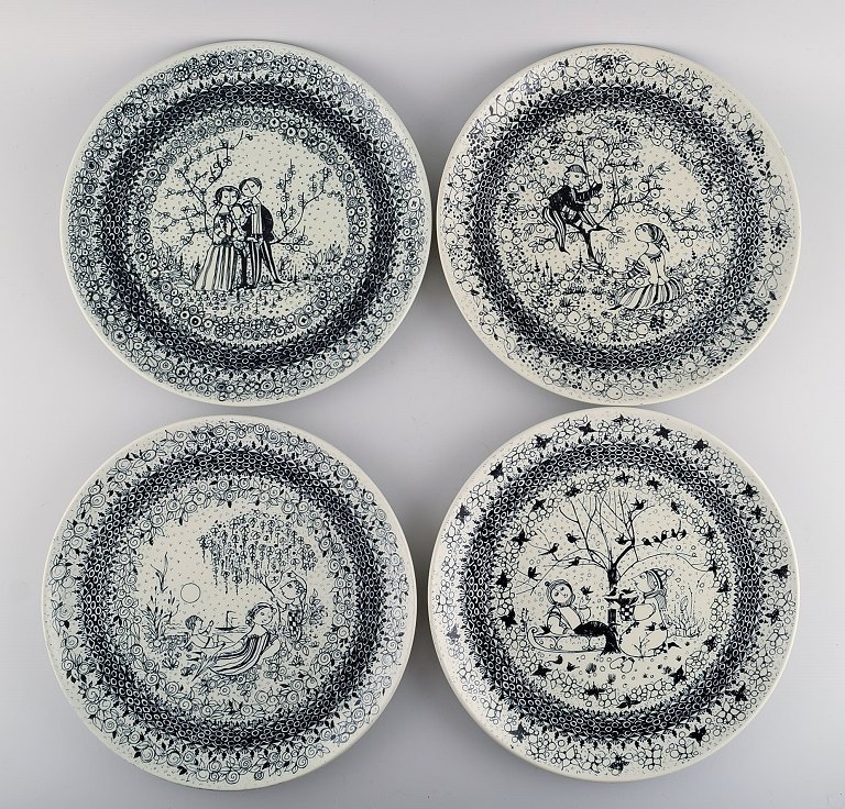 Bjørn Wiinblad for Nymølle. Four round Seasons dishes in glazed faience. 1970s / 
80s.
