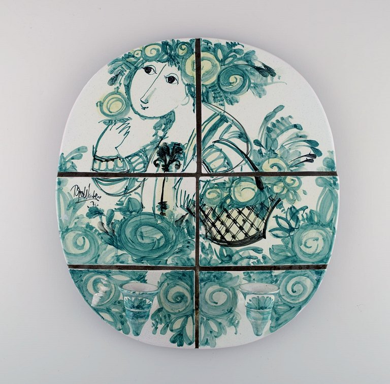 Bjørn Wiinblad (1918-2006). Unique wall candlestick / relief with two light arms 
made of green glazed ceramic tiles, decorated with woman with flower basket. 
Dated 1974.

