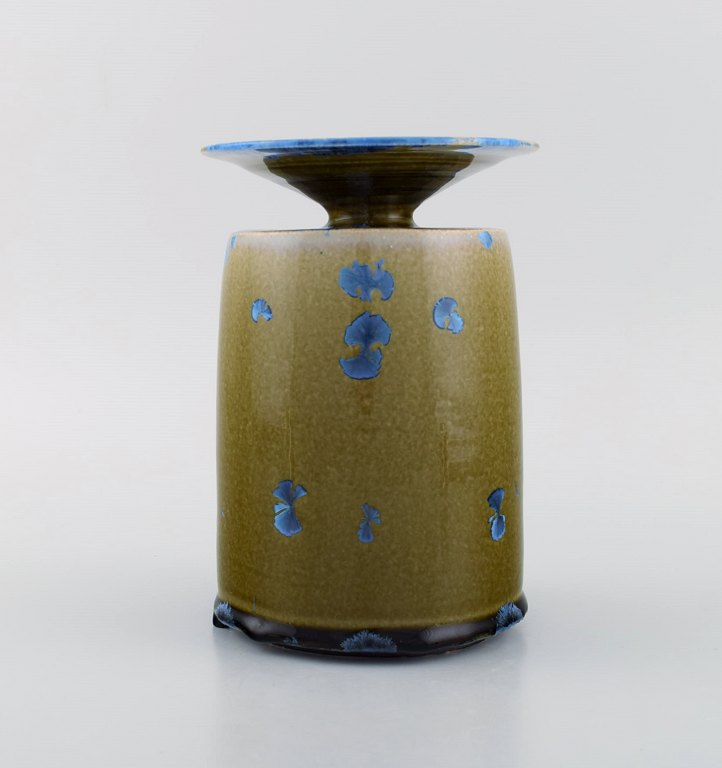 Isak Isaksson, Swedish ceramicist. Unique vase in glazed ceramics. Beautiful 
crystal glaze in blue and earth shades. Late 20th century.
