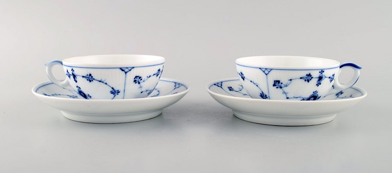 Two antique Royal Copenhagen Blue Fluted Plain teacups with saucers. Model 
number 1/76. Dated 1894-1900.

