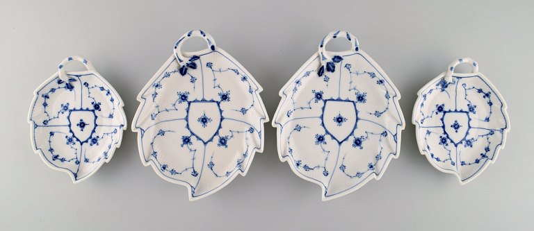 Four antique Royal Copenhagen Blue Fluted Plain Leaf-shaped dishes with handles. 
19th century.
