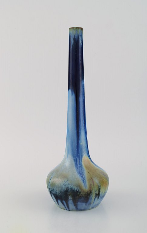 Gentil Sourdet, France. Long necked vase in glazed stoneware. Beautiful glaze in 
shades of blue and green. Mid-20th century.
