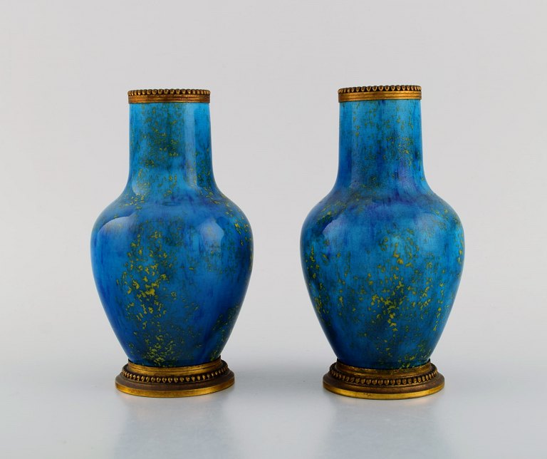 Paul Milet (1870-1930) for Sevres, France. Two vases in glazed ceramics with 
brass mounts. Beautiful glaze in light blue shades. 1920s.
