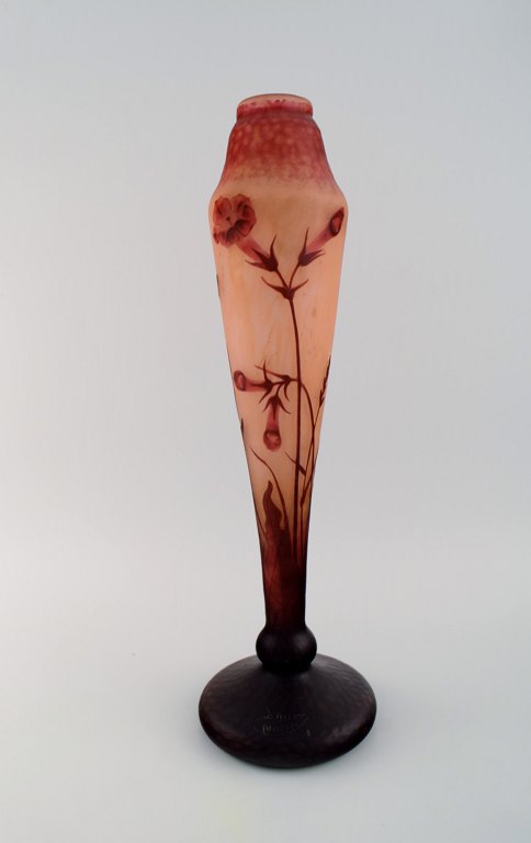 Daum Nancy, France. Large "Tobacco flowers" multilayer glass vase with an etched 
decor of red flowers on a yellow-orange and pink background. Early 20th century. 
Museum quality.
