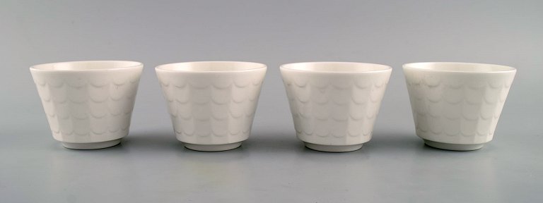 Wilhelm Kåge for Gustavsberg. Four flower pot covers in porcelain. Swedish 
design, 1960s.

