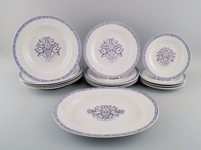 Wilhelm Kåge for Gustavsberg. Vas serving dish and fifteen plates in 
hand-painted faience. 1920s / 30s.
