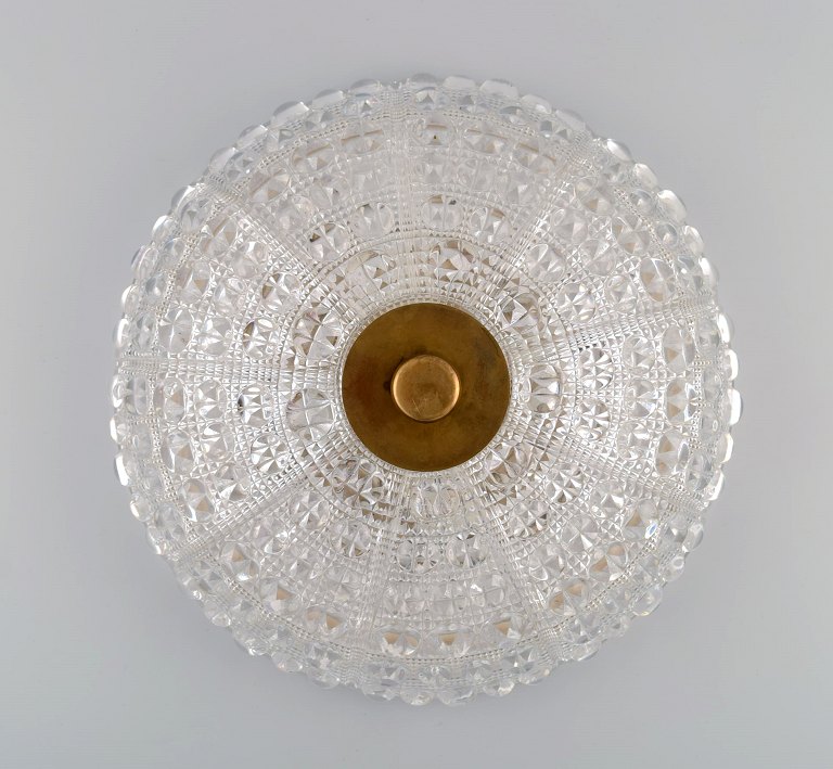 Orrefors wall / ceiling lamp in clear art glass and brass. 1970s.

