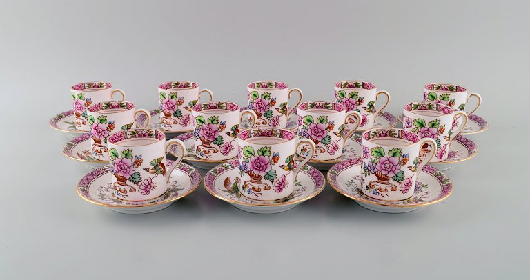 Coalport, England. Twelve Tuscan coffee cups with saucers decorated with flowers 
and gold edge. 1930