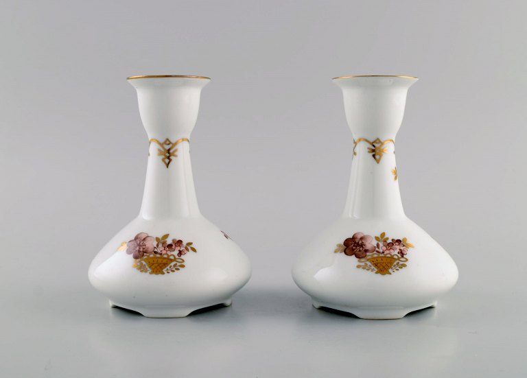 Two Royal Copenhagen Golden Basket candlesticks in porcelain with flowers and 
gold decoration. Model number 595/430.
