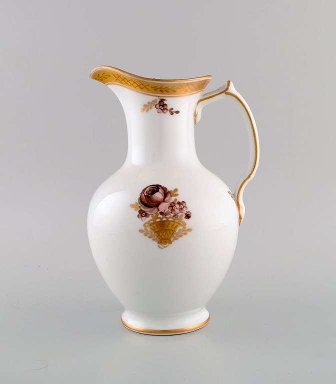 Royal Copenhagen Golden Basket chocolate jug in porcelain with flowers and gold 
decoration. Model number 595/9424. Early 20th century.
