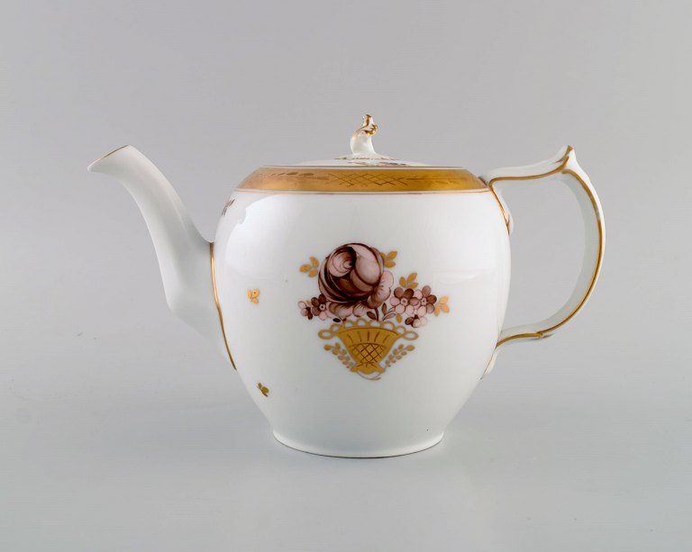 Royal Copenhagen Golden basket teapot in porcelain with flowers and gold 
decoration. Model number 595/9103. Early 20th century.

