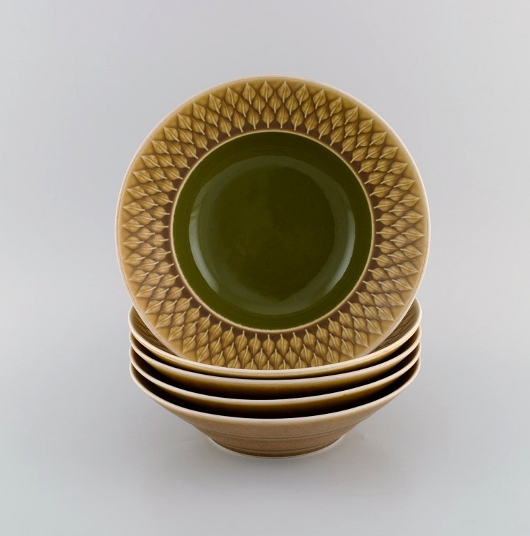 Jens H. Quistgaard (1919-2008) for Bing & Grøndahl. Five Relief deep plates in 
glazed stoneware. Beautiful glaze in mustard yellow and green shades. 1960s.

