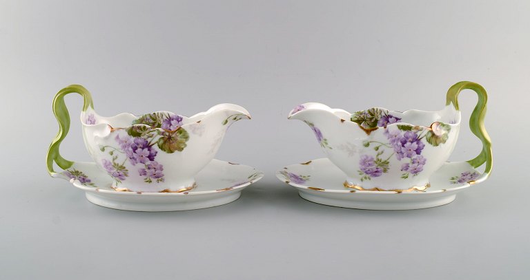 Rosenthal, Germany. Two Iris sauce boats in hand-painted porcelain with flowers 
and gold edge. Handles modeled as foliage. 1920s.
