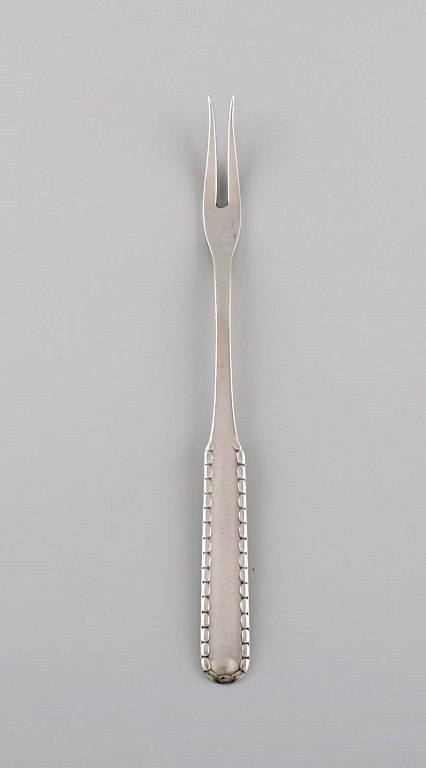 Early Georg Jensen Rope cold meat fork in silver (830). Dated 1915-1930.
