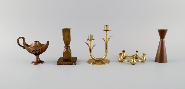 Quistgaard, Gusum, Ystad Metall et al. Oil lamp and four candlesticks in brass. 
1930-1970s.
