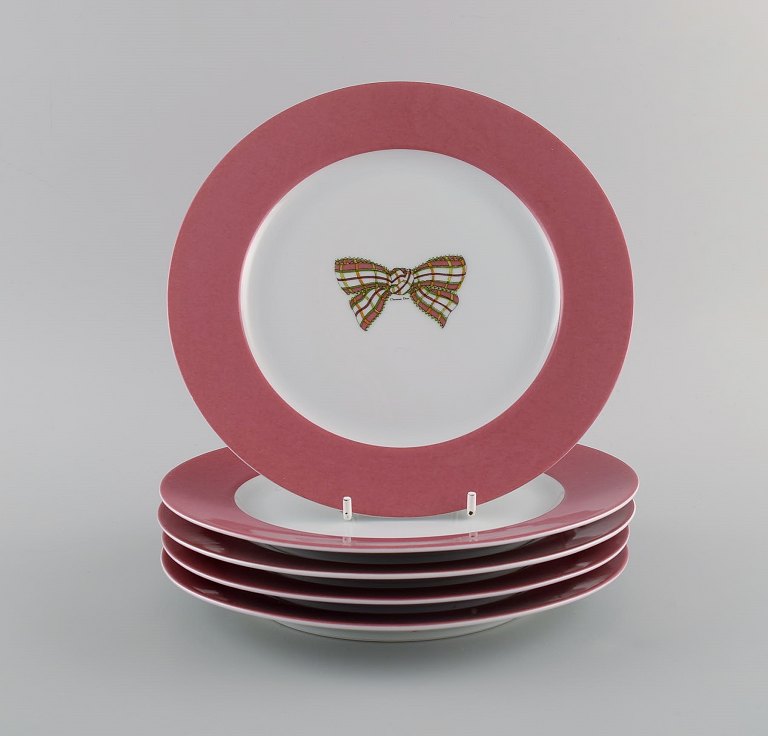 Limoges, France. Five Christian Dior porcelain plates decorated with bow and 
pink border. 1980s.
