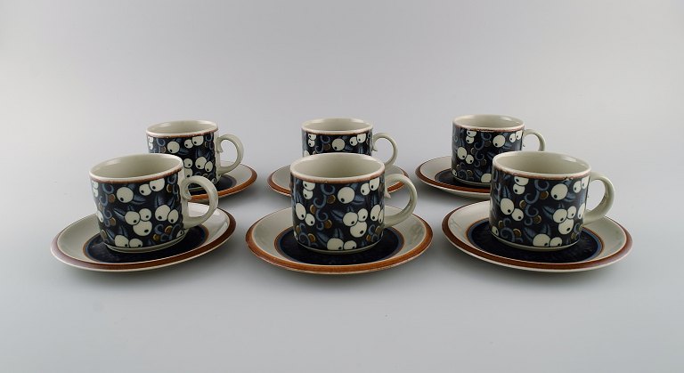 Inkeri Seppälä for Arabia. Six Taika coffee cups with saucers in glazed 
stoneware decorated with blue and white berries. 1970s.
