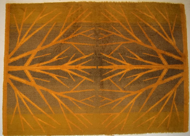 Swedish textile designer. Large hand-woven RÖLAKAN rug in pure wool decorated 
with trees in beautiful autumn colors. 1960/70