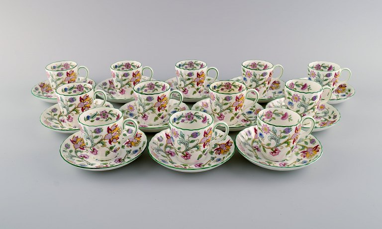 Minton, England. Twelve Haddon Hall mocha cups with porcelain saucers. Colorful 
flowers and light green border. 1930s.
