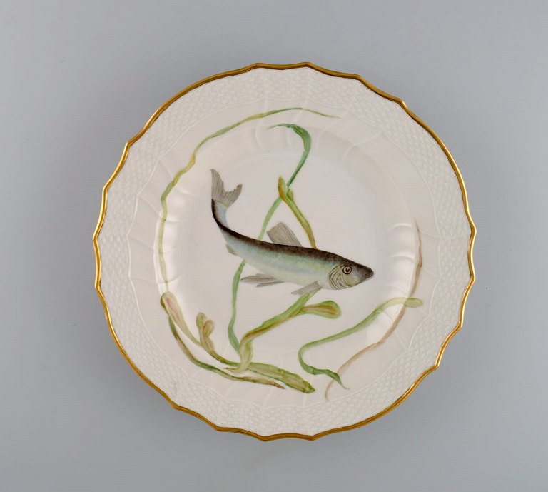 Royal Copenhagen porcelain dinner plate with hand-painted fish motif and golden 
border. Flora / Fauna Danica style. Dated 1968.
