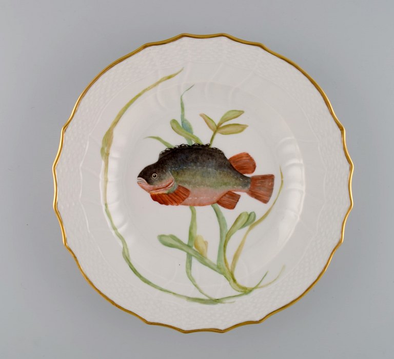 Royal Copenhagen porcelain dinner plate with hand-painted fish motif and golden 
border. Flora / Fauna Danica style. Dated 1968.
