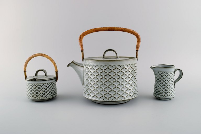 Jens H. Quistgaard (1919-2008) for Bing & Grøndahl / Nissen Kronjyden. Gray 
Cordial teapot, sugar bowl and creamer in glazed stoneware. 1960s.

